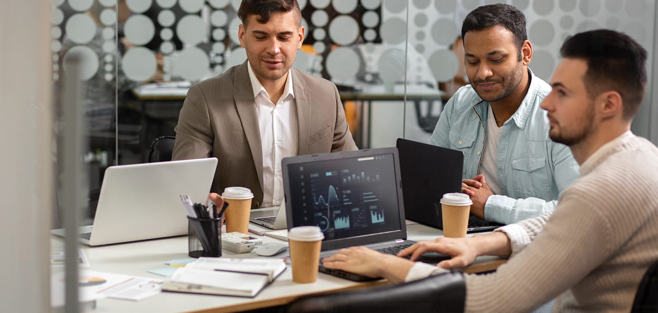 Business professionals reviewing website analytics, operational data, and digital performance metrics during a team meeting.